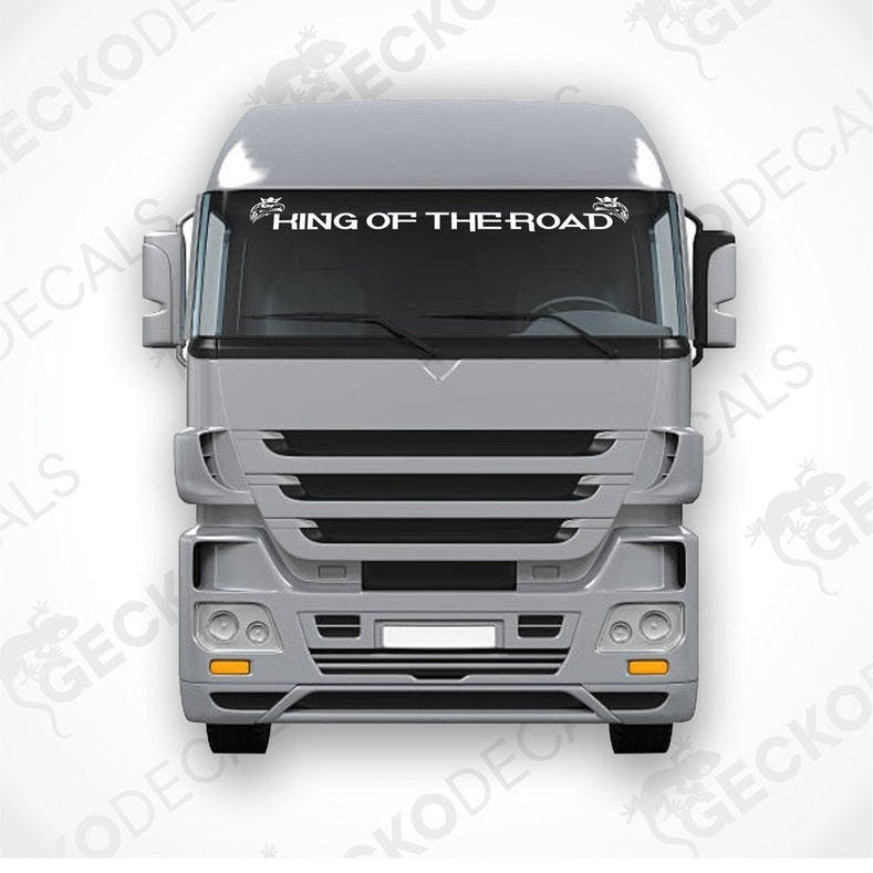 A die cut decal with the text 'KING OF THE ROAD' displayed on the windscreen of a gray Scania truck.