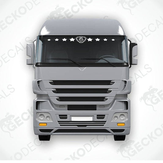 A front view of a truck windshield with a decal of multiple white stars arranged in a line across the top.