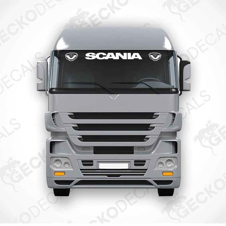 A front view of a gray Scania truck with a die cut decal on the windscreen.