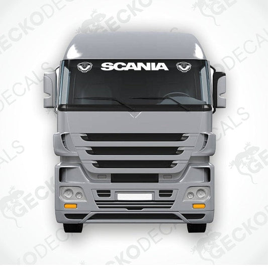 A front view of a gray Scania truck with a die cut decal on the windscreen.