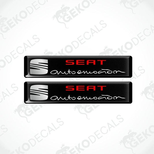 Two black vinyl decals with polyurethane coating featuring the SEAT AUTOEMOUTION logo in withe lettering.