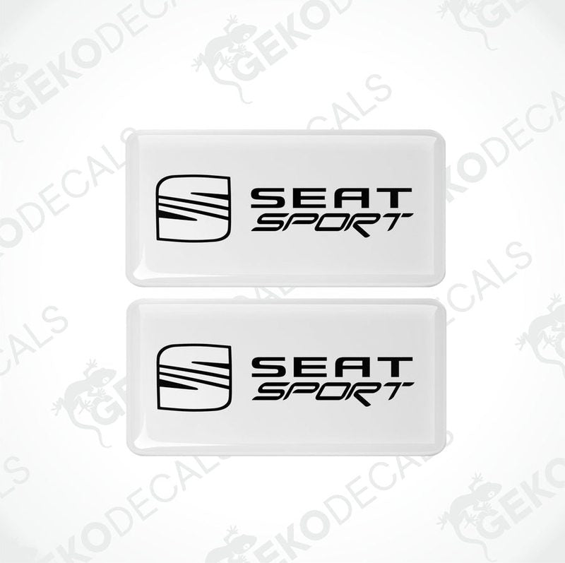 Two withe rectangular car decals with the black text 'SEAT SPORT' on them.