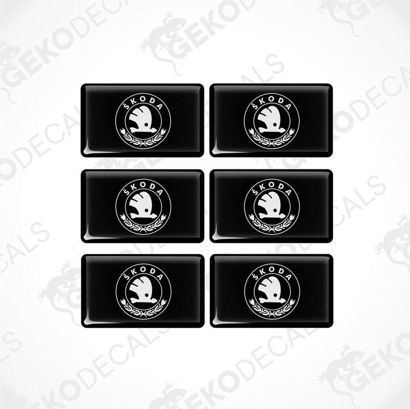 A set of six black vinyl stickers with the Škoda Auto logo in white.