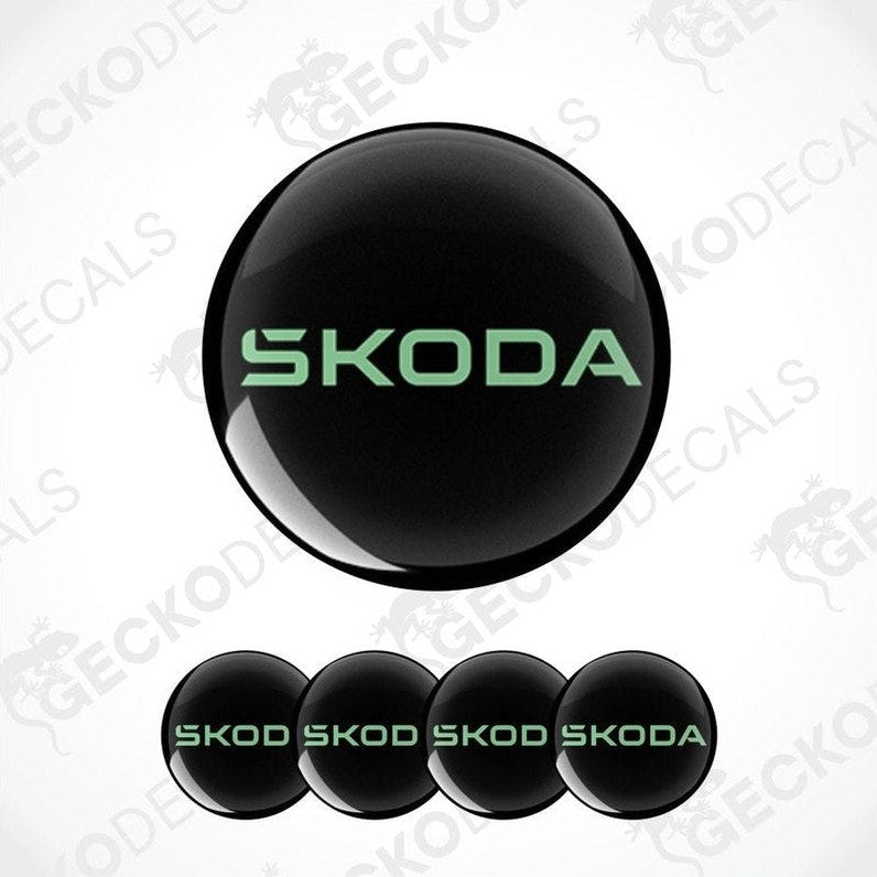 Set of Skoda logos in green on black circular backgrounds with a white background.