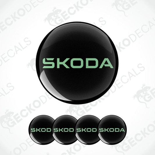 Set of Skoda logos in green on black circular backgrounds with a white background.