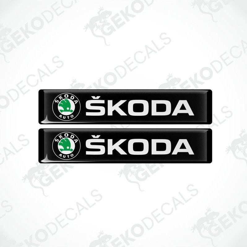 Two black decals with the Skoda logo and the text 'SKODA AUTO' in white.