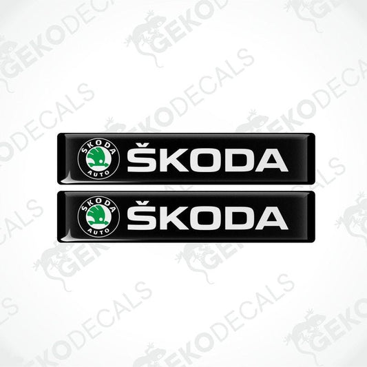 Two black decals with the Skoda logo and the text 'SKODA AUTO' in white.