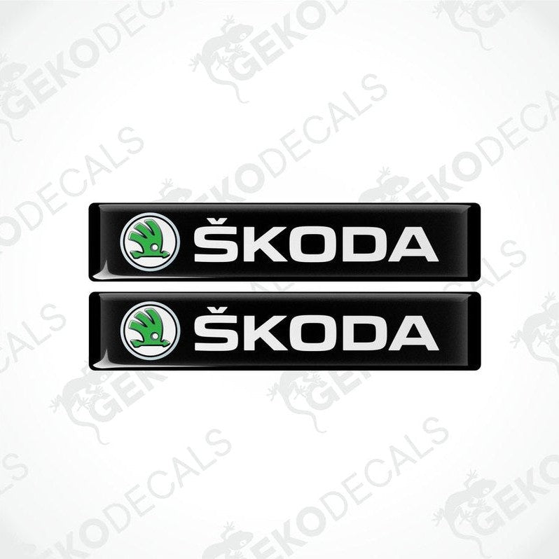 Two black decals with the Skoda logo and the text 'SKODA AUTO' in white.