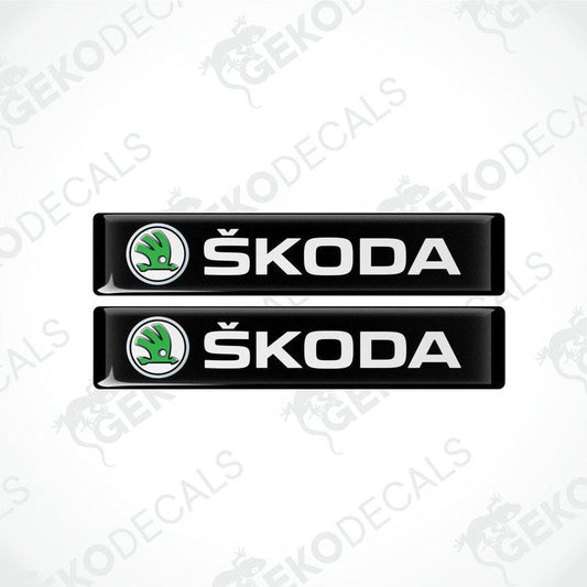Two black decals with the Skoda logo and the text 'SKODA AUTO' in white.