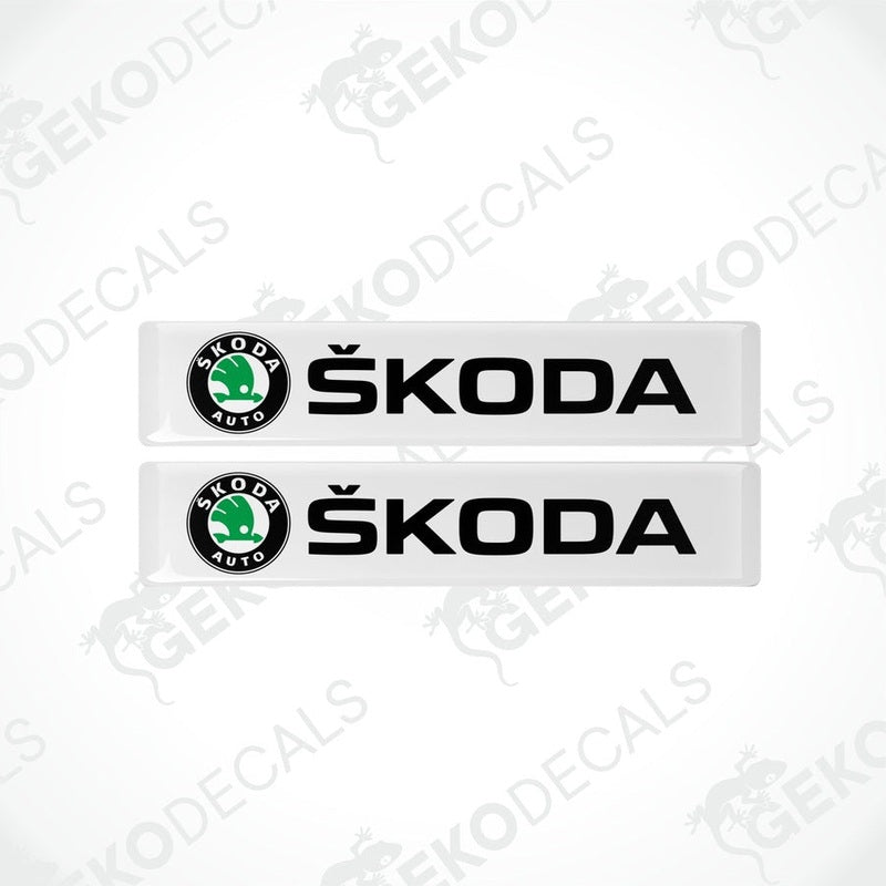 Two withe decals with the Skoda logo and the text 'SKODA AUTO' in black.