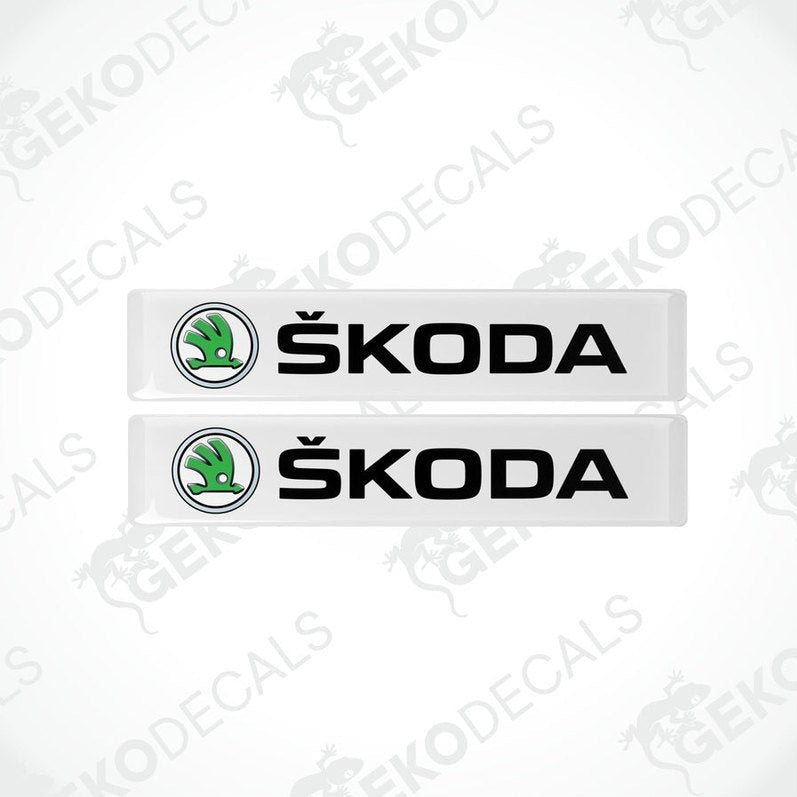 Two withe decals with the Skoda logo and the text 'SKODA AUTO' in black.