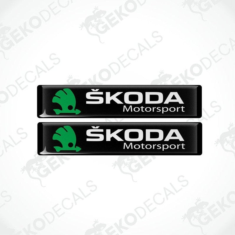 Two black, green, and white decals with the Skoda Motorsport logo.