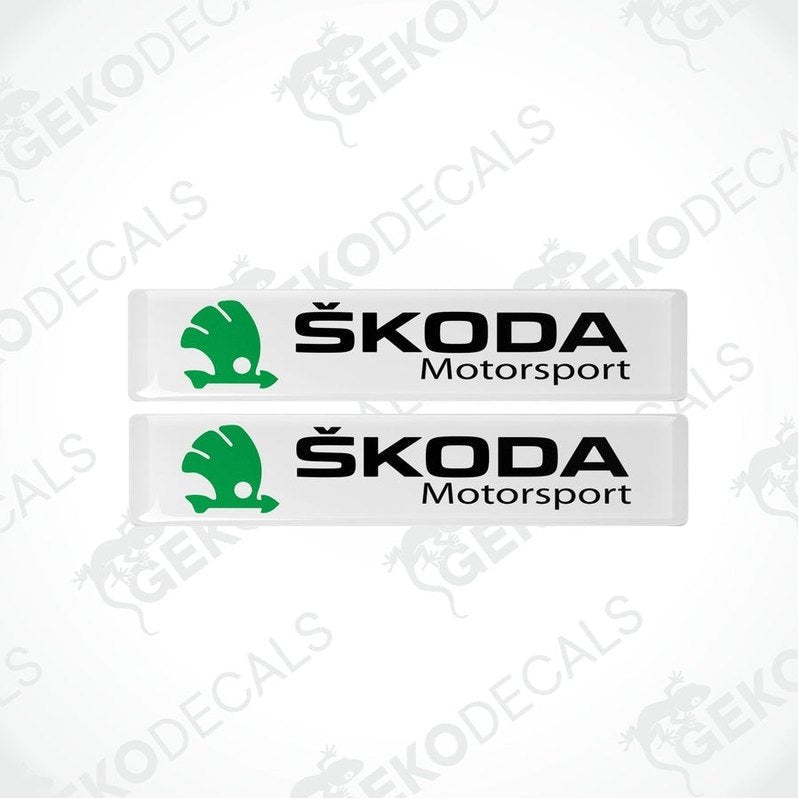 Two withe, green, and black decals with the Skoda Motorsport logo.