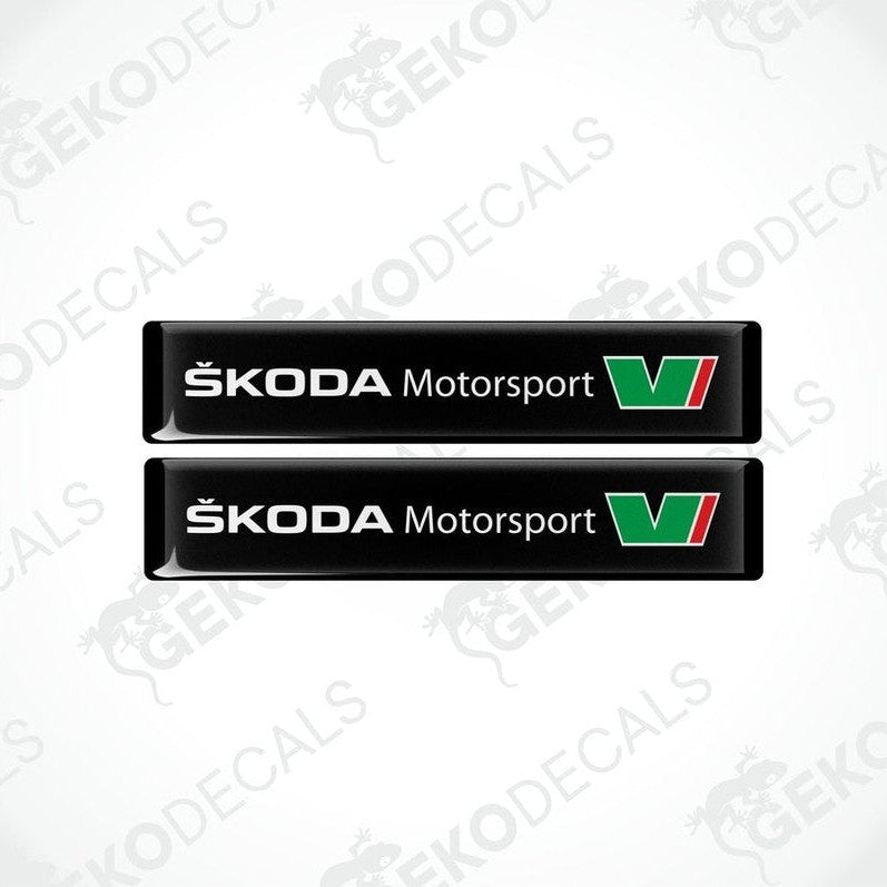 Two black rectangular decals with the Skoda Motorsport logo in green and white.