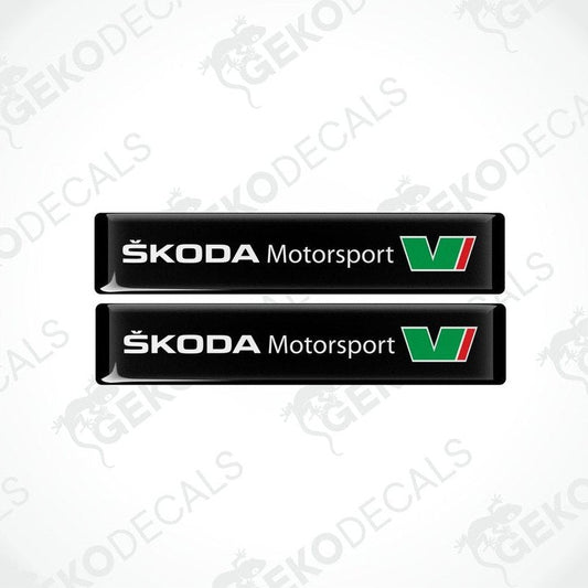 Two black rectangular decals with the Skoda Motorsport logo in green and white.