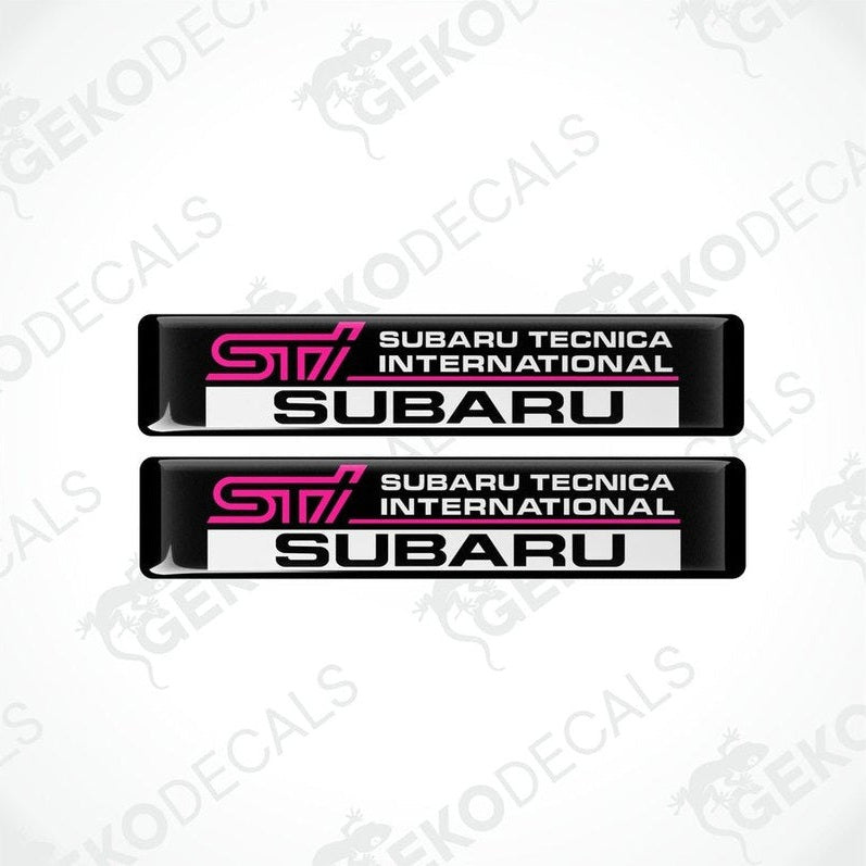 Two rectangular black decals with 'STI SUBARU TECNICA INTERNATIONAL' text in pink and white.
