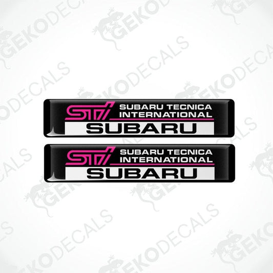 Two rectangular black decals with 'STI SUBARU TECNICA INTERNATIONAL' text in pink and white.