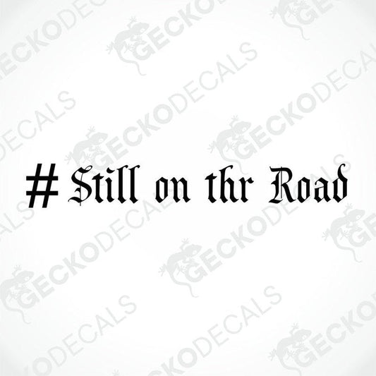 A die cut sticker with the text '# STILL ON THE ROAD' displayed on a white background, with a Gecko Decals logo at the bottom.