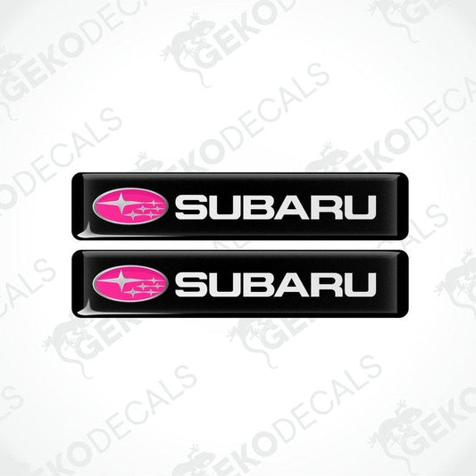 Two black vinyl stickers with the word 'SUBARU' written in white and a pink star symbol on each sticker.