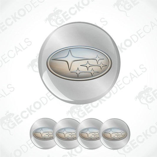 Set of four metallic Subaru logo emblems on a white background.