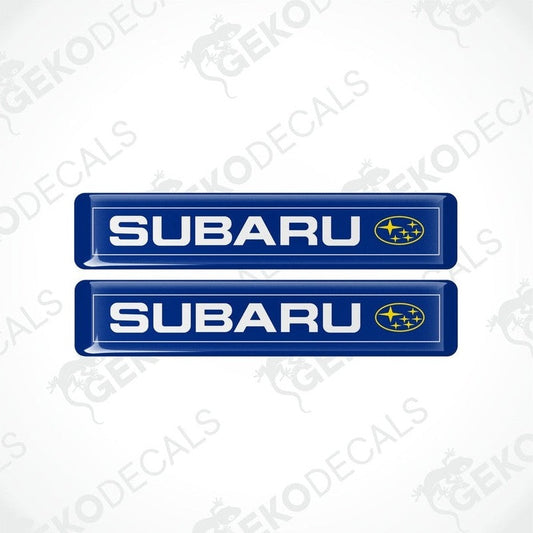 Two blue vinyl decals with the Subaru brand logo in white and yellow.