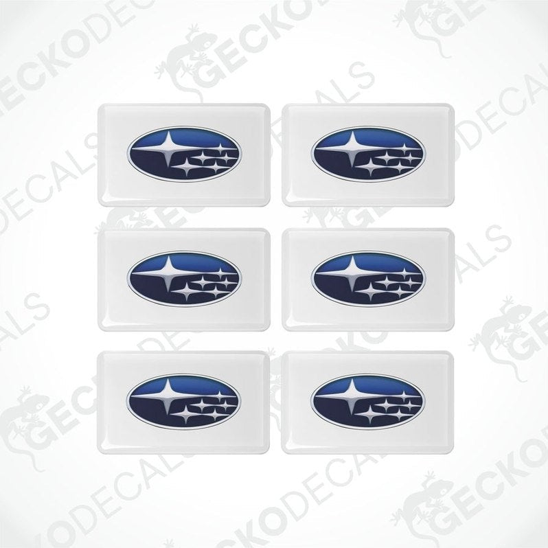 A set of six withe, blue, and white vehicle decals featuring the Subaru logo.