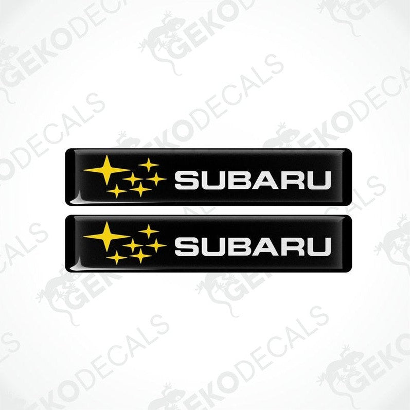 Two black vinyl stickers with the Subaru brand logo and star graphics.