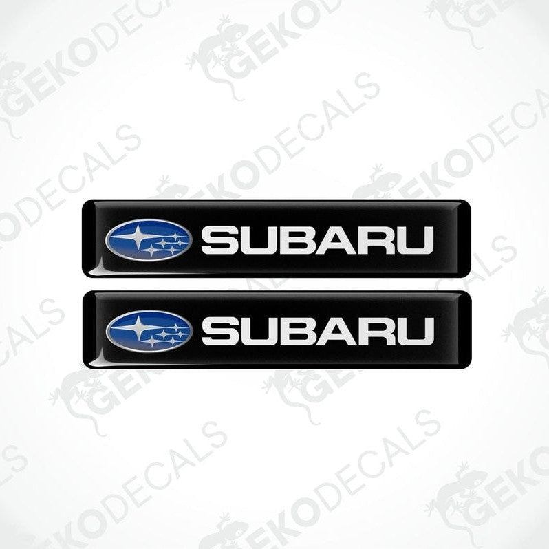 Two black vinyl decals with the Subaru logo in white.