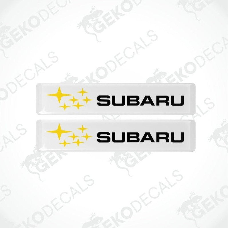 Two withe vinyl stickers with the Subaru brand logo and star graphics.