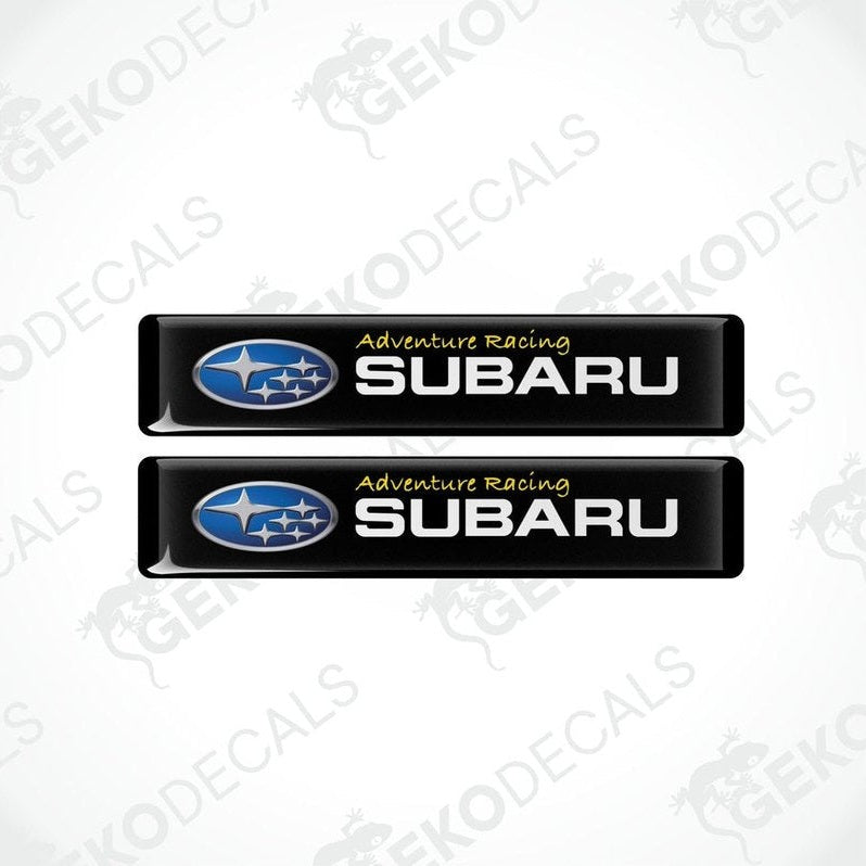 Two black vinyl stickers with the text 'ADVENTURE RACING' and the Subaru logo.