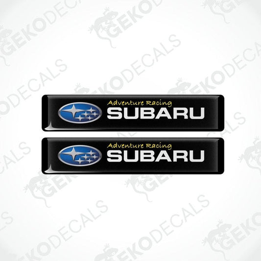 Two black vinyl stickers with the text 'ADVENTURE RACING' and the Subaru logo.