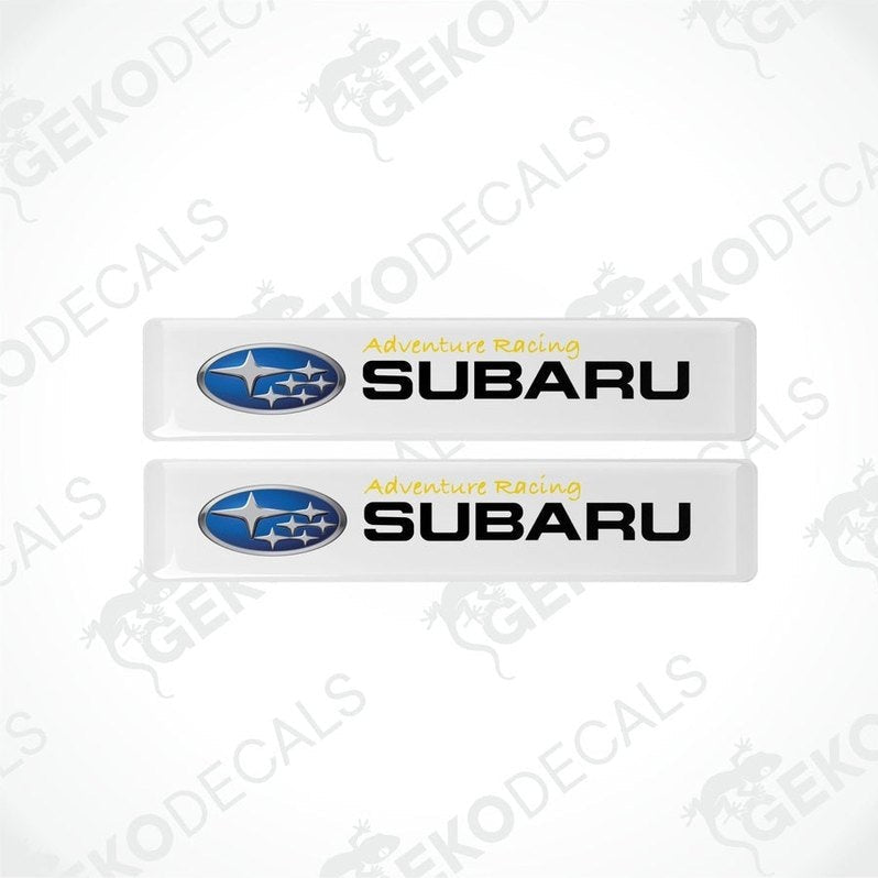 Two withe vinyl stickers with the text 'ADVENTURE RACING' and the Subaru logo.