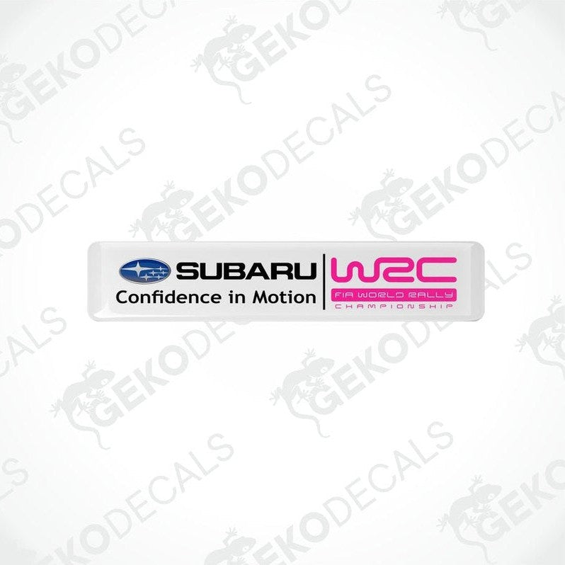 Rectangular vinyl decals with a polyurethane coating featuring the Subaru logo and 'Confidence in Motion' slogan in pink and white colors.