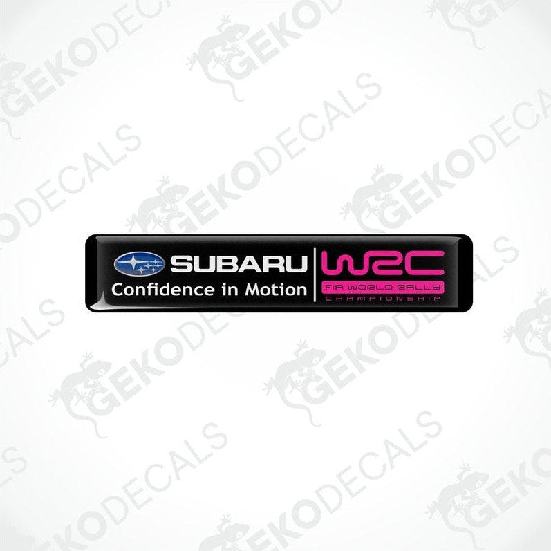 Rectangular vinyl decals with a polyurethane coating featuring the Subaru logo and 'Confidence in Motion' slogan in pink and black colors.