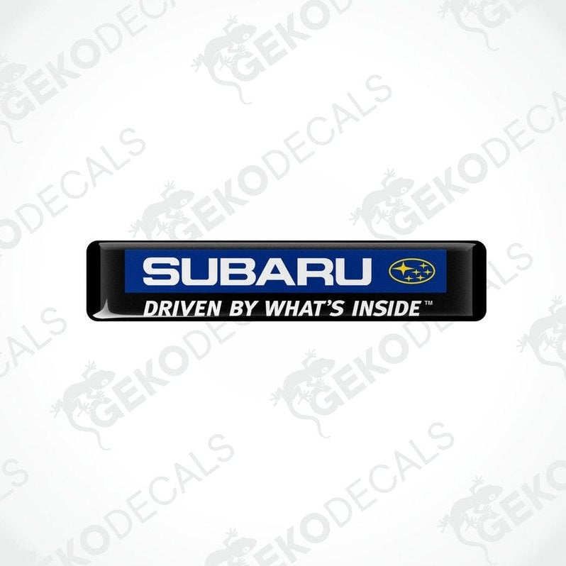 Black rectangular decals with the Subaru logo and the text 'The Beauty of All-Wheel Drive'.