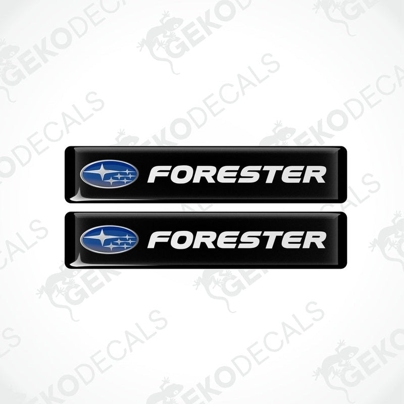 Two black vinyl stickers with the word 'FORESTER' and a graphical representation of a car above the text.