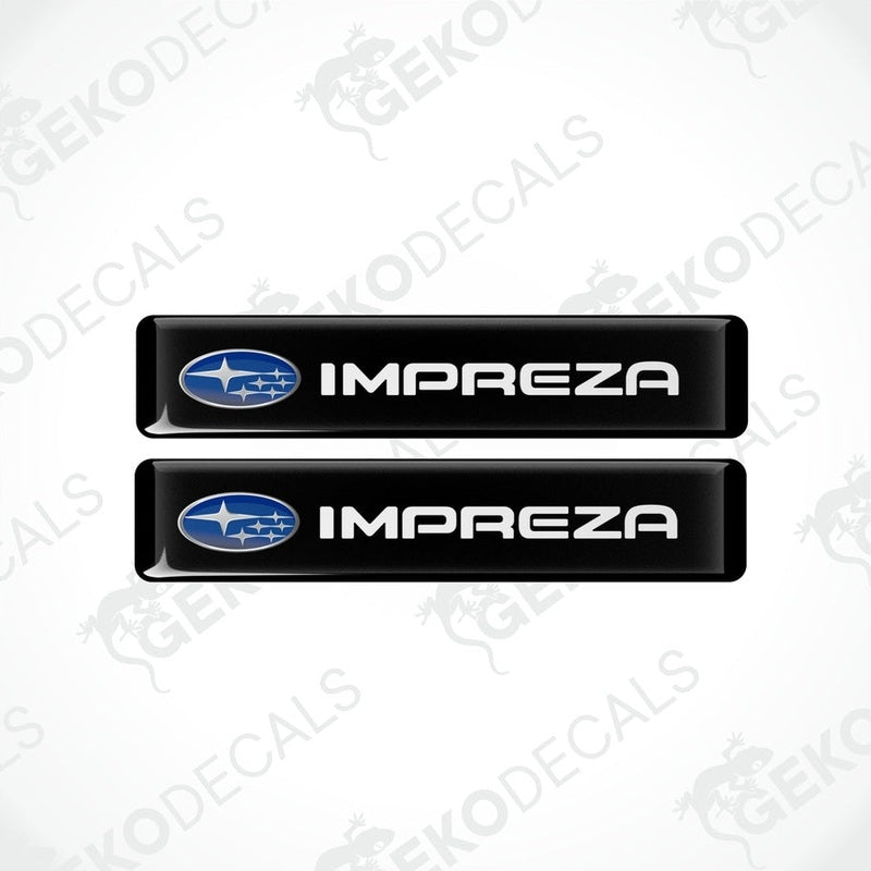 Two black vinyl stickers with the SUBARU IMPREZA brand logo printed on them