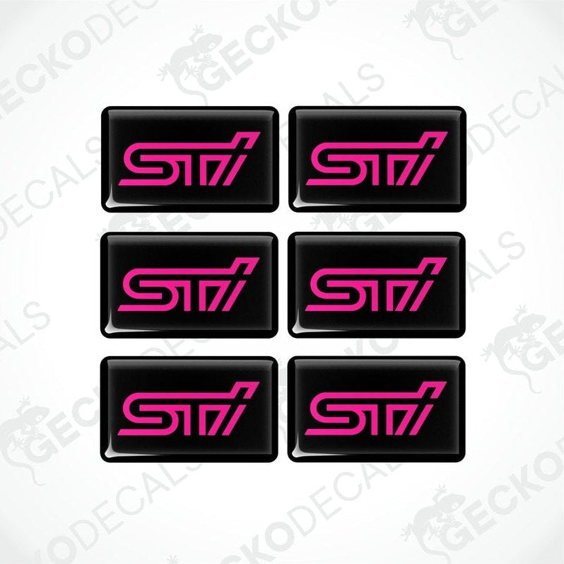 A set of six black vinyl stickers with the word 'STI' in pink lettering.