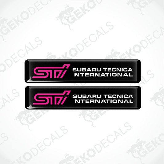 Two black decals with pink and white text that read 'STI SUBARU TECNICA INTERNATIONAL'.