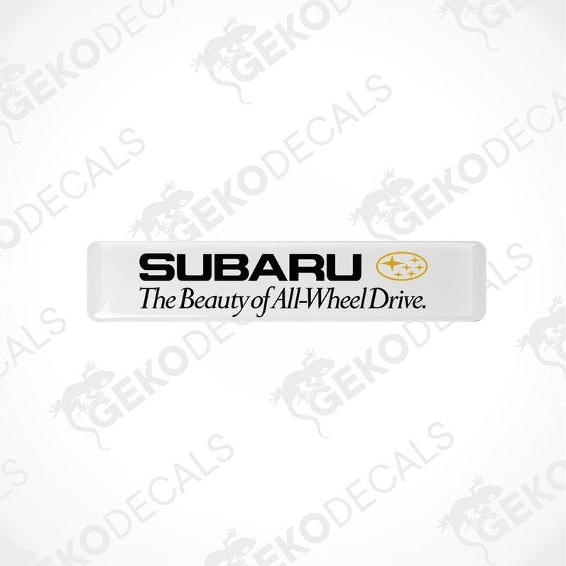 Withe rectangular decals with the Subaru logo and the text 'The Beauty of All-Wheel Drive'.