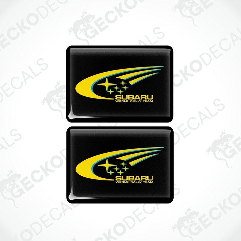 Two black vinyl stickers with the SUBARU brand logo and stars.