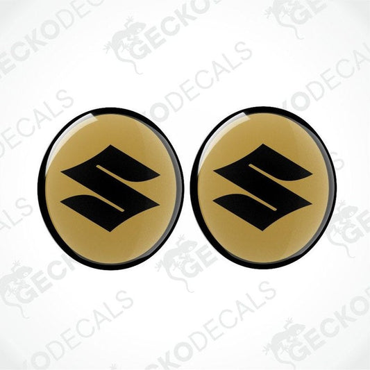 Two gold and black Suzuki logos on a white background with 'Gecko Decals' branding.