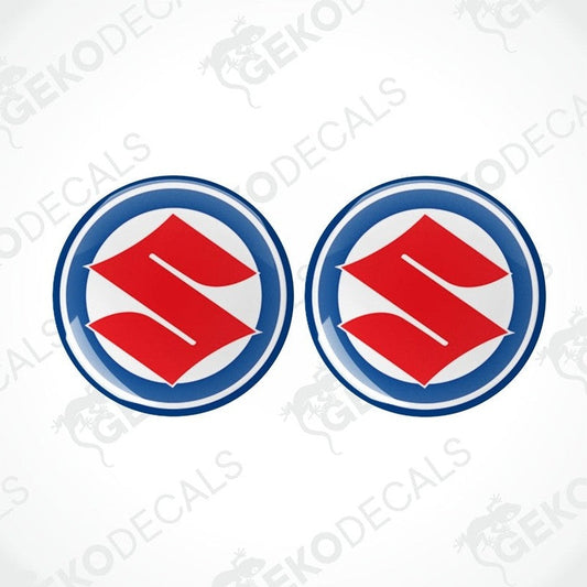 Two round blue, red, and white decals with the SUZUKI logo.