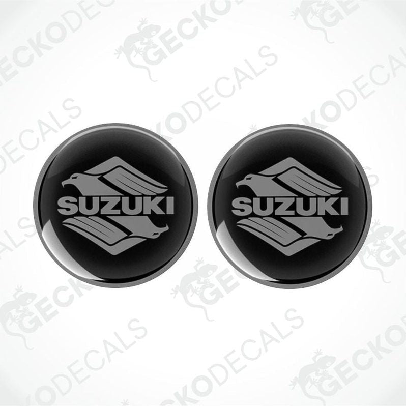 Two black Suzuki logo stickers on a white background with 'Gecko Decals' branding.