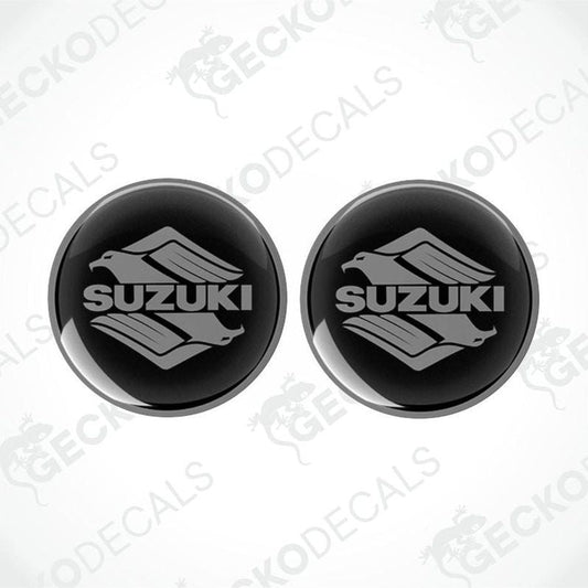 Two black Suzuki logo stickers on a white background with 'Gecko Decals' branding.
