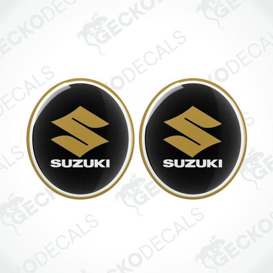 Two Suzuki logos on black background with gold outline