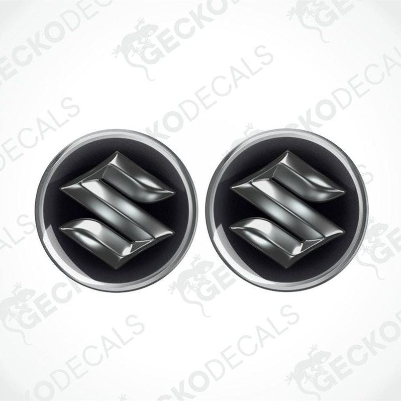 Two metallic Suzuki logos epoxy decals on a white background with 'Gecko Decals' branding.
