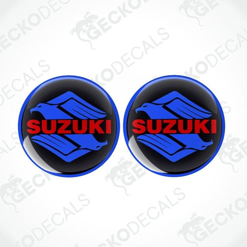 Two Suzuki logos with blue and red design on a white background with 'Gecko Decals' watermark.