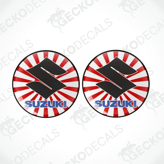 Two Suzuki logo decal stickers with red and white circular designs on a white background.