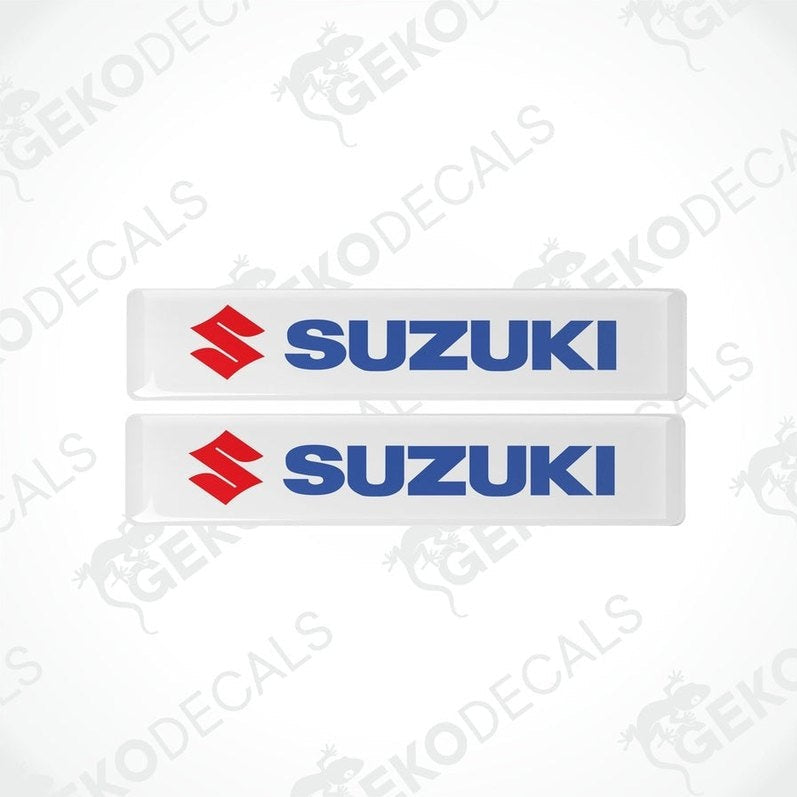 Two withe vinyl stickers with the SUZUKI logo in blue and red.